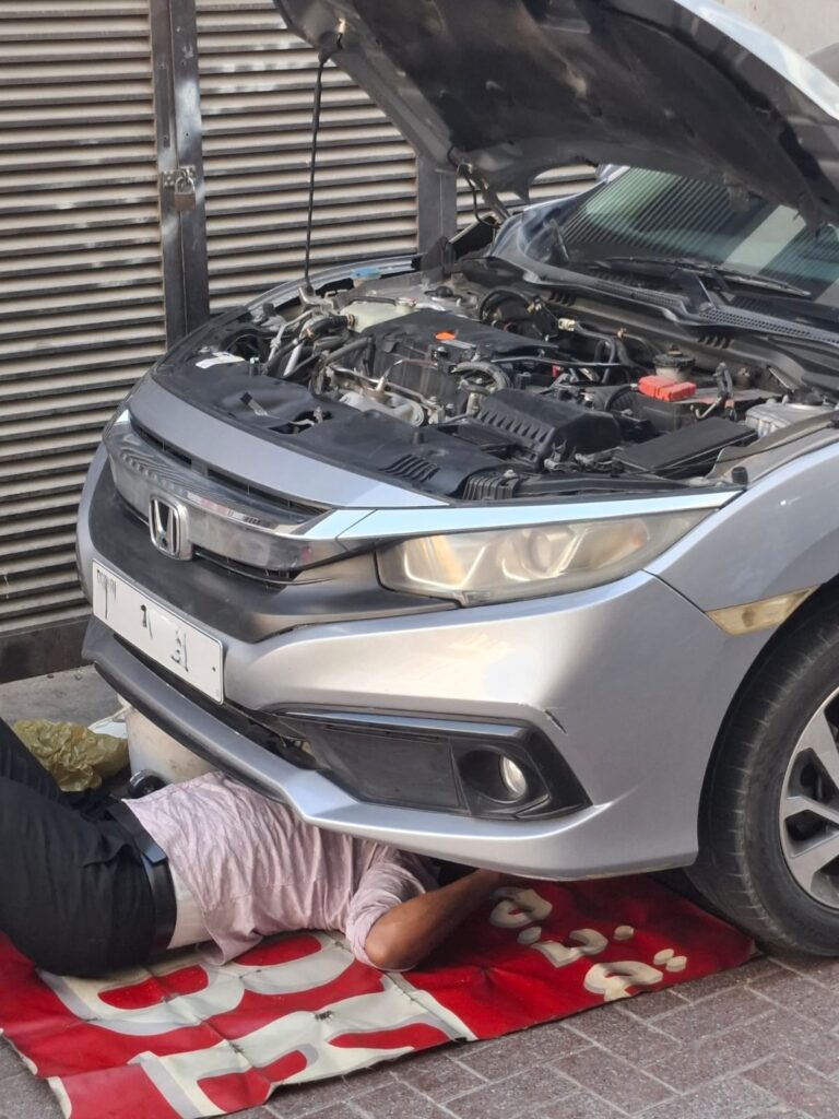 Mobile car mechanic changing engine oils 768x1024